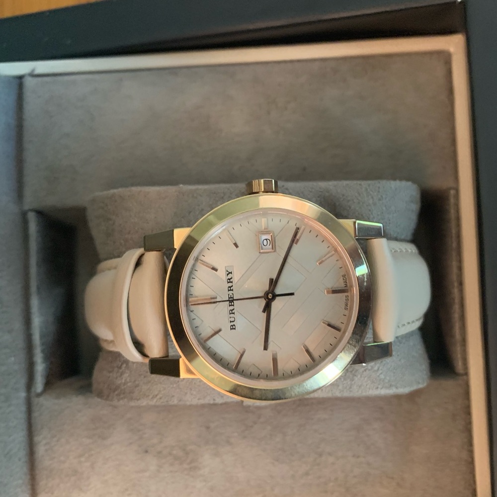 Rose gold Burberry watch with leather band.
